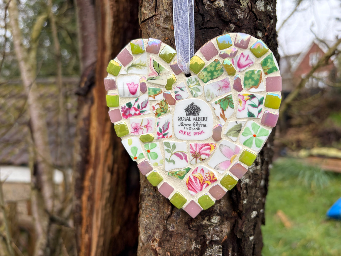 Close-up of Royal Albert Pixie Pink mosaic heart showing floral china detail and tile border