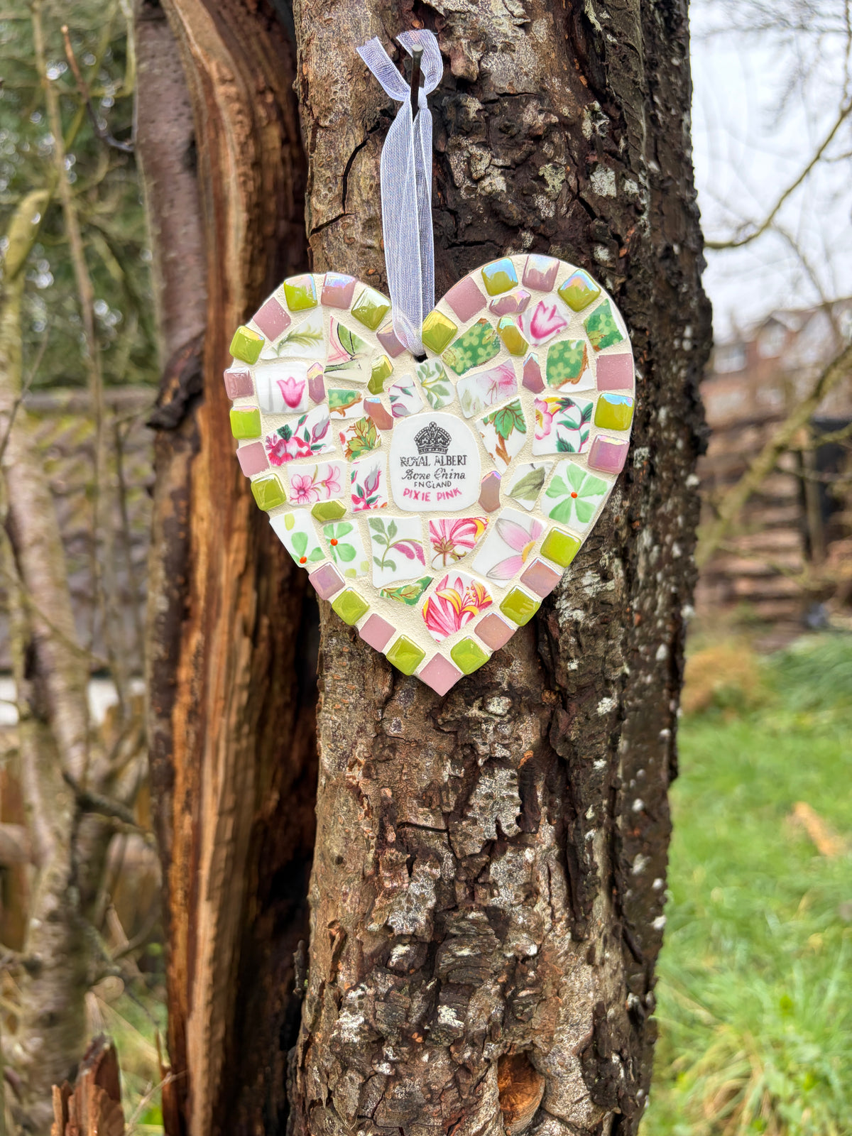 Royal Albert Pixie Pink mosaic heart hanging on a tree showing full piece from a distance