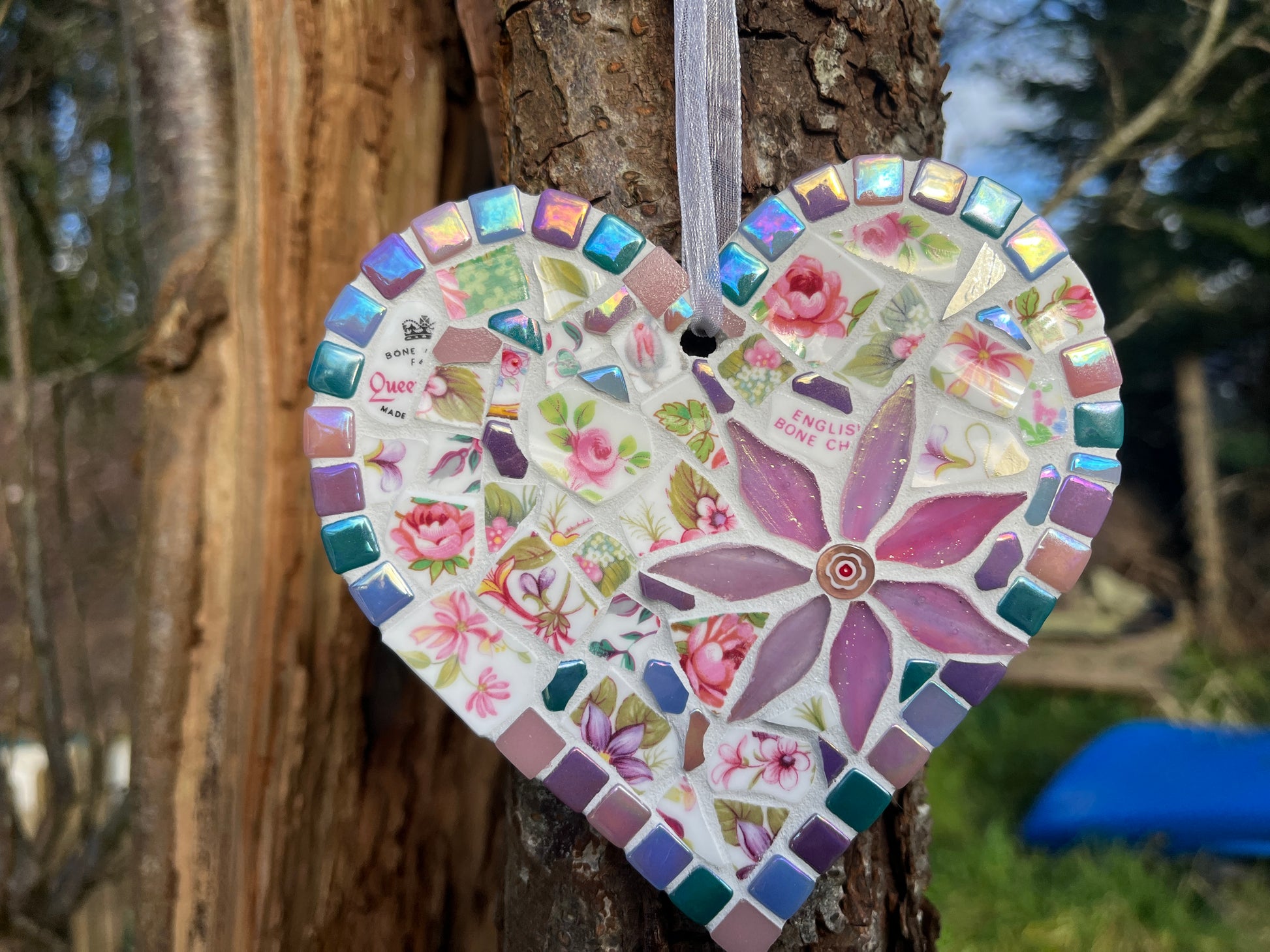 Full view of Queen's bone china rose mosaic heart with iridescent border tiles catching the light
