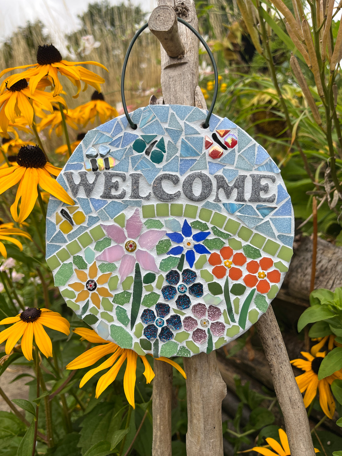Custom floral mosaic garden welcome sign on slate, circular, 15.5cm, with vibrant flower tiles and metal hanging loop